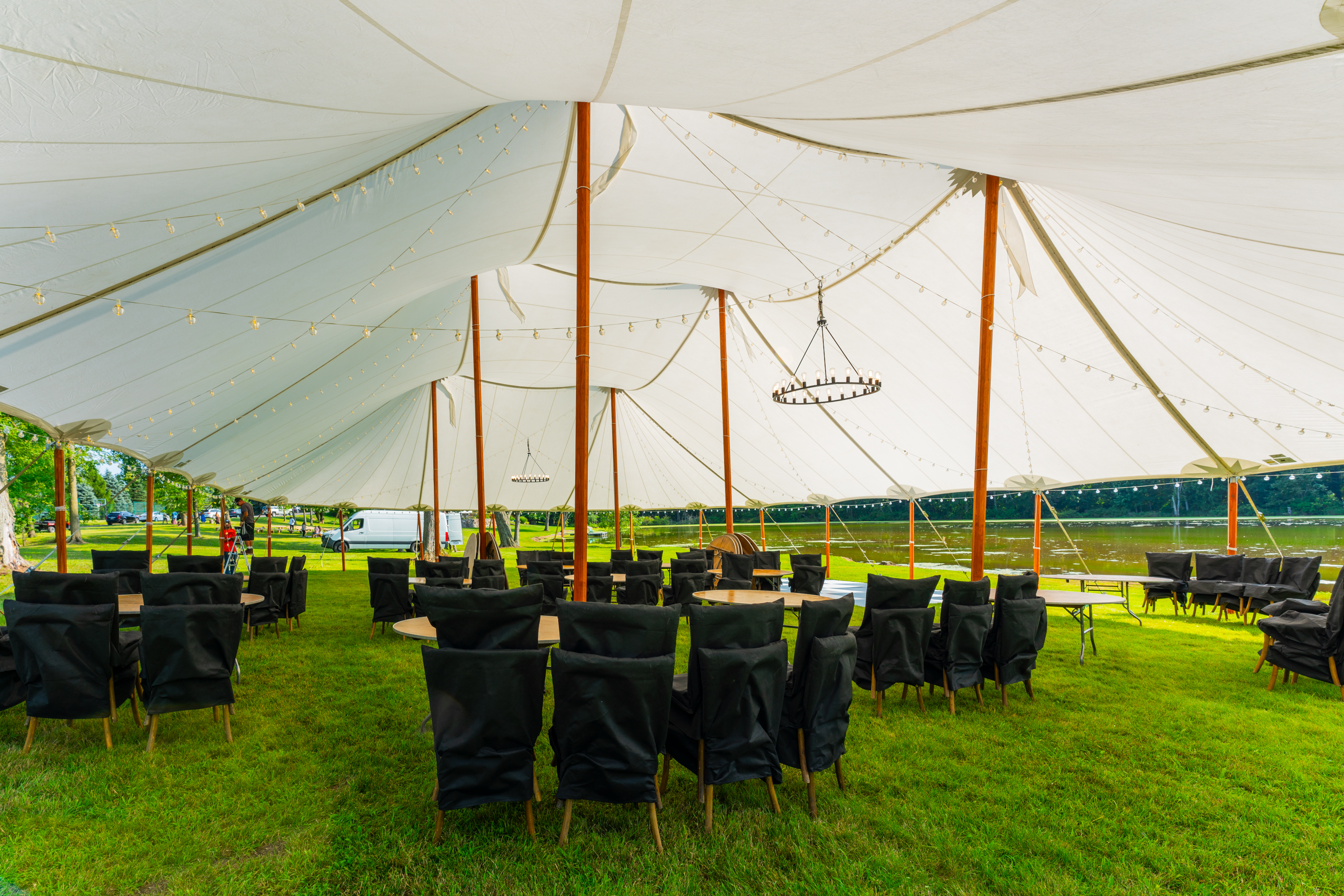 Large sailcloth tent with seating for outdoor worship service and church gathering